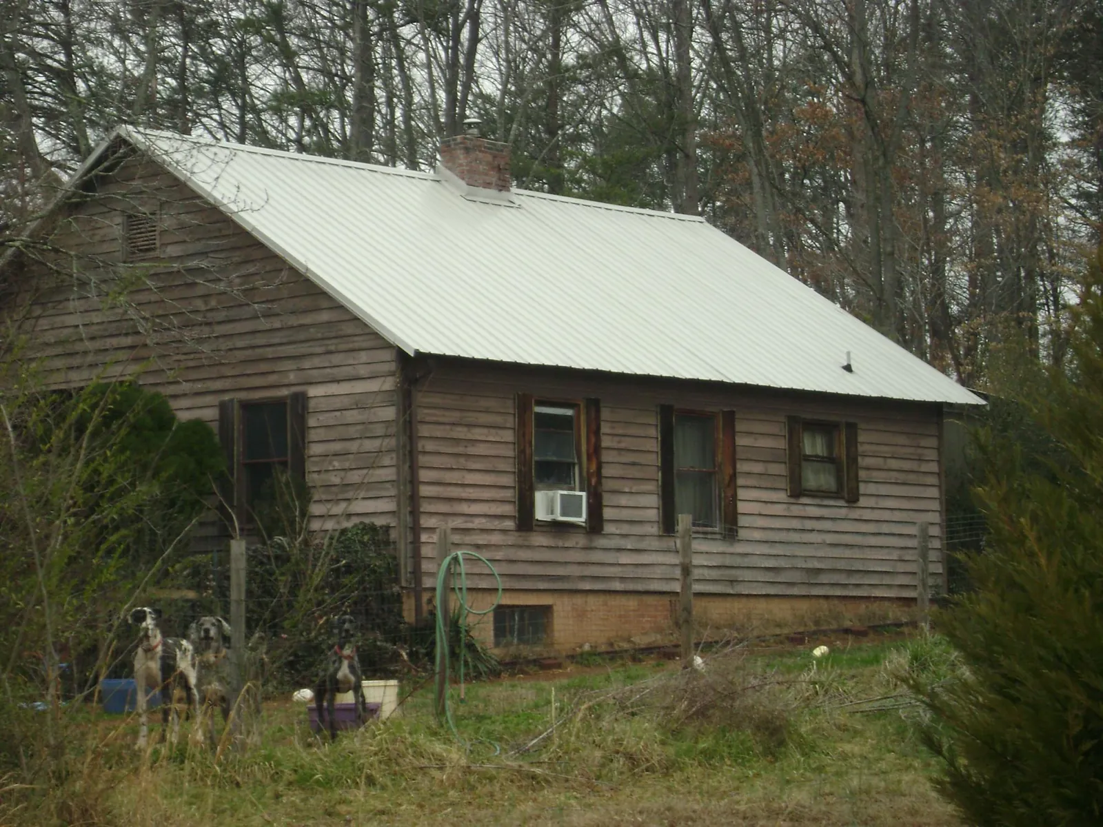 White metal roof on an old wood sided farmhouse, from a Metal Roof Installation job in Shellsburg